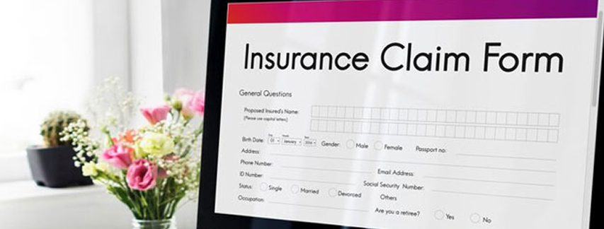 Digital insurance claim form displayed on an office computer